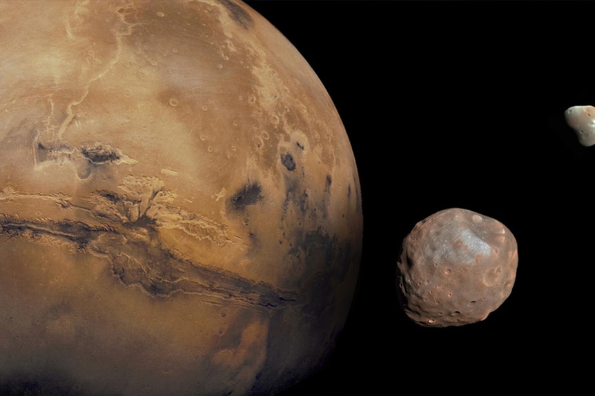 Mars, alongside its two moons, Phobos and Deimos.
