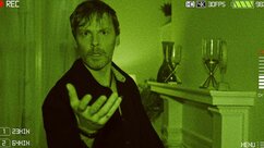 Kit Rampart (Brian Marler) holds his hand out on night vision footage in SurrealEstate 202.