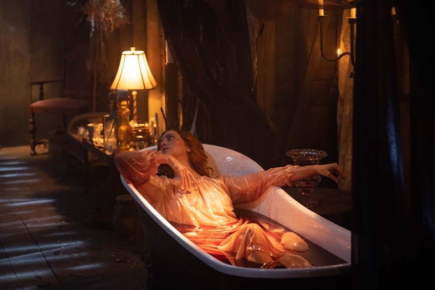 Kay (Tara Yelland) wears a white dress in a bloody bath in SurrealEstate 204