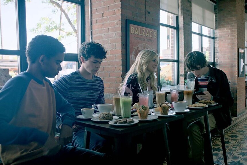 (l-r) Devon Evans (Bjorgvin Arnarson), Jake Wheeler (Zachary Arthur),  Lexy Cross (Alyvia Alyn Lind), and Grant Collins (Jackson Kelly) sit at a table full of food in Chucky 302 -- “Let the Right One In”