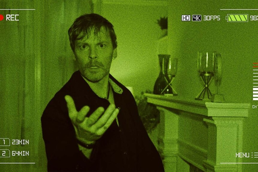 Kit Rampart (Brian Marler) holds his hand out on night vision footage in SurrealEstate 202.