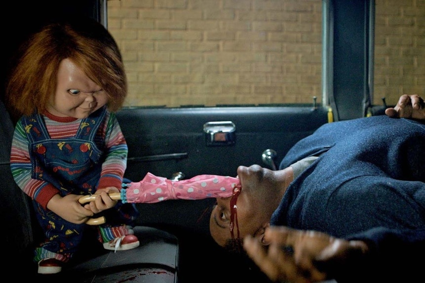 Chucky shoves a pink umbrella down a bleeding man's throat in a car in Chucky Episode 303 -- "Jennifer's Body."