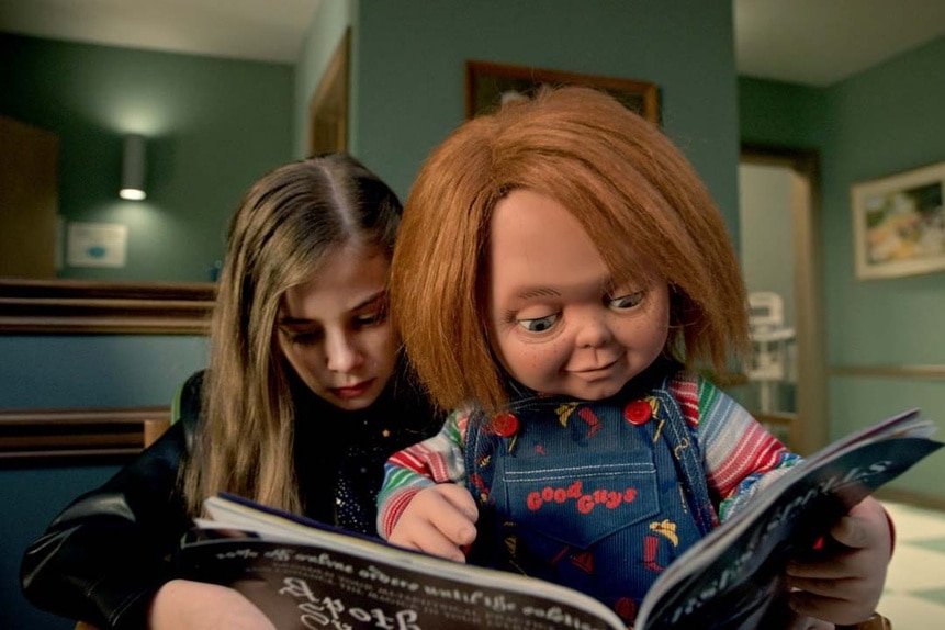 Caroline Cross (Carina Battrick) reads a book with Chucky in Chucky 303.