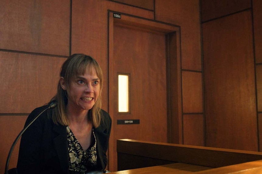 Fiona Dourif as Nica Pierce (Fiona Dourif) appears scowling on a witness stand in court in Chucky 303.
