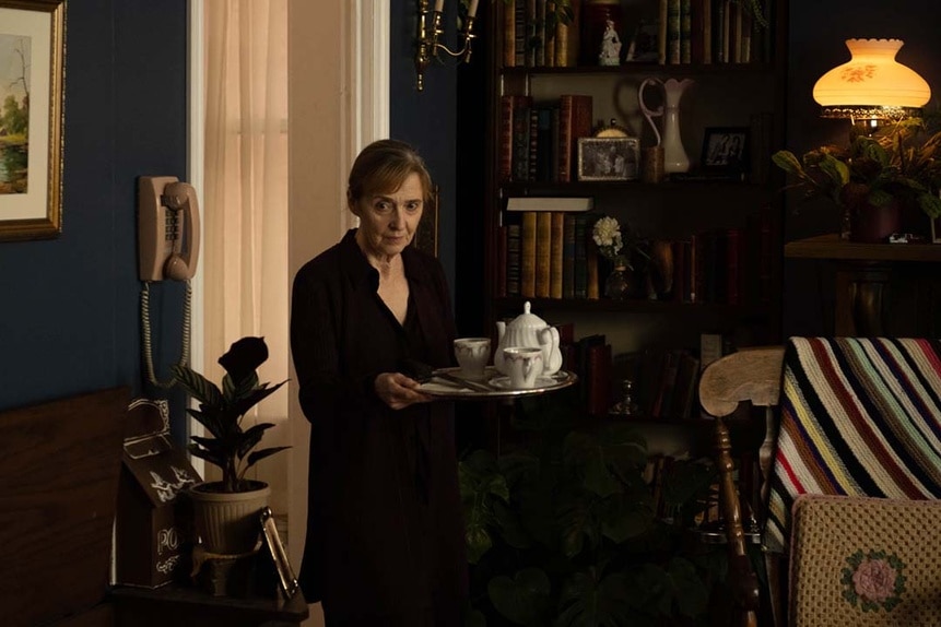 Elsa (Brenda Bazinet) holds a tea tray in SurrealEstate 207