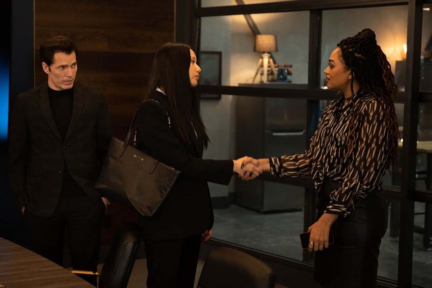 Lomax (Elena Juatco) and Zooey L'Enfant (Savannah Basley) shake hands as Luke Roman (Tim Rozon) watches in SurrealEstate 207.