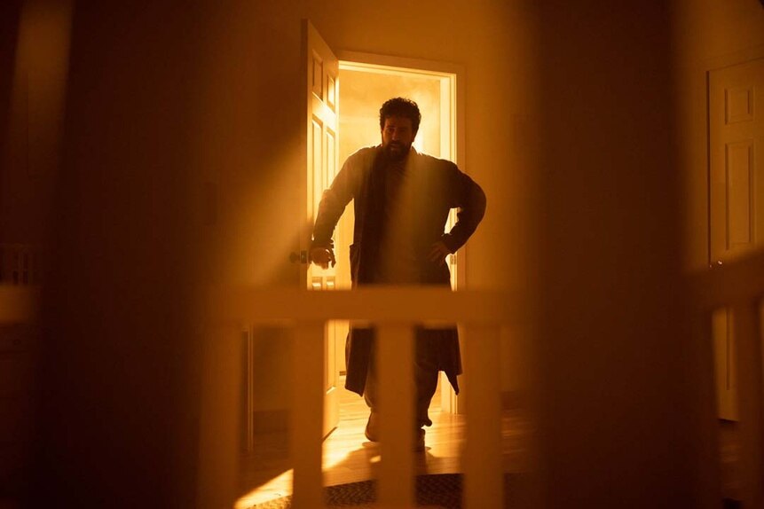 Father Phil Orley (Adam Korson) appears in a doorway in SurrealEstate 208