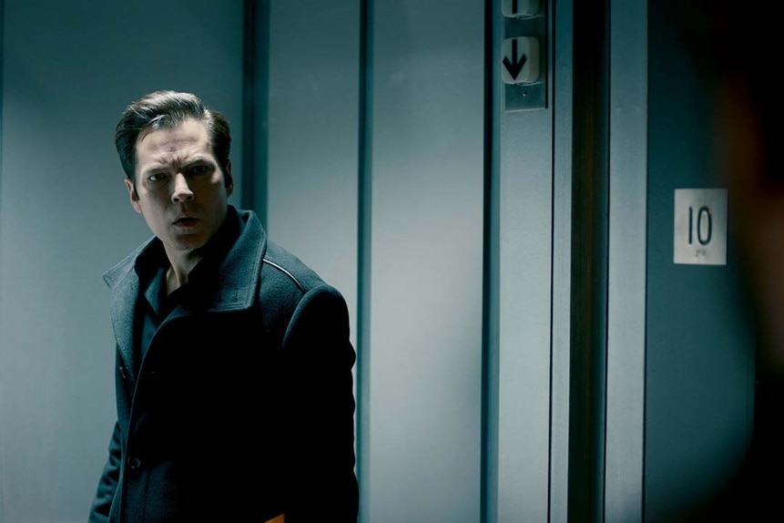 Luke Roman (Tim Rozon) looks baffled near an elevator in SurrealEstate 205.