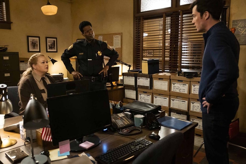 Deputy Liv Baker (Elizabeth Bowen), Sheriff Mike Thompson (Corey Reynolds), and Mayor Ben Hawthorne (Levi Fiehler) stand in an office together in Resident Alien episode 306.