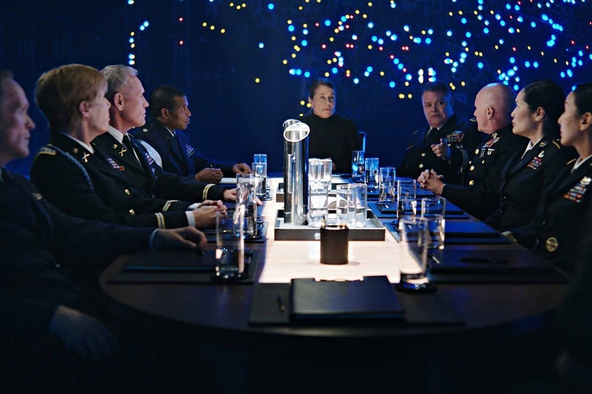 General Eleanor Wright sits at the head of a military meeting in Resident Alien Episode 304.