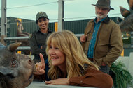 (from left) A baby Nasutoceratops, Dr. Ellie Sattler (Laura Dern) and Dr. Alan Grant (Sam Neill) in Jurassic World Dominion.