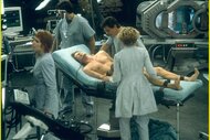 Kevin Bacon in Hollow Man (2000) on an operating table as doctors operate on him.