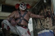 A shot from Twisted Metal featuring a man in a clown mask