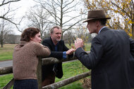 Emily Blunt (as Kitty Oppenheimer) with writer, director, and producer Christopher Nolan and Cillian Murphy (as J. Robert Oppenheimer) on the set of OPPENHEIMER.