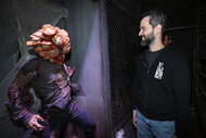 Neil Druckmann admires a The Last of Us monsters at the Opening Night Celebration of Halloween Horror Nights at Universal Studios Hollywood