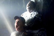 Jim (William Sadler) screams in front of a man encased in spider webbing in The Mist (2007).