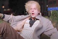 Doc (Christopher Lloyd) is bathed in light as he looks shocked in Back to the Future (1985).