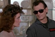 Dr. Peter Venkman (Bill Murray) wears sunglasses and looks at a young woman in Ghostbusters II (1989).
