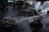 The DeLorean blows smoke in a parking lot in Back to the Future (1985).