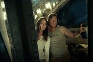 Vivian Wembley (Laura Haddock) and Cade Yeager (Mark Wahlberg) peer out a massive window together in Transformers: The Last Knight (2017).