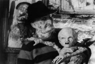 Freddy Krueger (Robert Englund) holds a baby version of himself for A Nightmare on Elm Street: The Dream Child (1989)