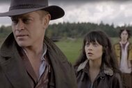Wyatt Cain (Neal McDonough) looks away from DG (Zooey Deschanel) while Glitch (Alan Cumming) and a forest appear in the background on Tin Man.
