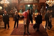 Peter (Kevin Durand) carries Abigail (Alisha Weir) while the cast stands next to him in Abigail (2024).