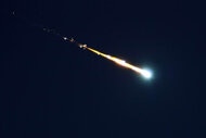 A fireball shooting across the night sky.