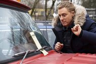 Harry Vanderspeigle looks at a ticket on a windshield in Resident Alien Episode 302.