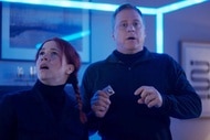 D'Arcy Bloom and Harry Vanderspeigle appears shocked in a glowing blue cube in Resident Alien Episode 302.