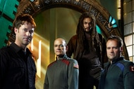 Lt. Col. John Sheppard (Joe Flanigan), Richard Woolsey (Robert Picardo), Ronan Dex (Jason Momoa), and Dr. Rodney McKay (David Hewlett) pose for Stargate Atlantis Season 5.