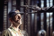 An alien hand reaches out to Brett (Harry Dean Stanton) in Alien (1979).