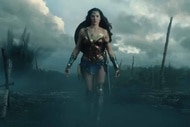 Wonder Woman (Gal Gadot) walks through a battlefield in Wonder Woman (2017).