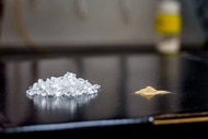 A pile of plastic pellets next to a pile of bacterial spores