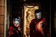 Murphy (Keith Allen) walks through a doorway in an orange Hazmat suit in Z Nation Episode 411.