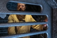 Harry Vanderspeigle (Alan Tudyk) looks through his cage bars on Resident Alien Episode 401.