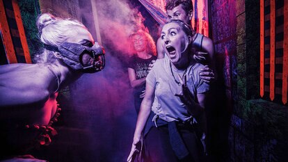 A girl screaming at a haunted house actor,