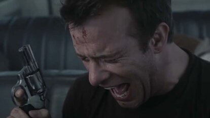 David Drayton (Thomas Jane) screams while holding a revolver in The Mist (2007).