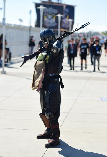 Cosplayers dress as Grogu and The Mandalorian on Day 2 of SDCC 2023