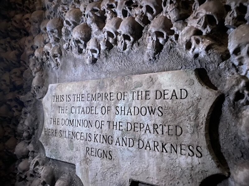 A plaque surrounded by skulls