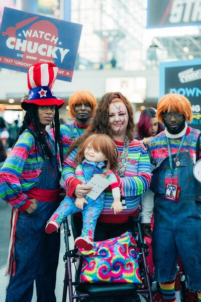 Comic-Con attendees hold Chucky dolls while dressed as Chucky at NYCC 2023 in Javits Center.