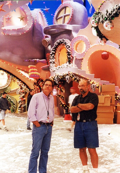 Michael Corenblith and Terry Scott stand on the whimsical wintery set of How the Grinch Stole Christmas (2000).