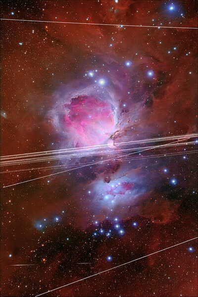 The Orion Nebula, crisscrossed with satellite streaks.