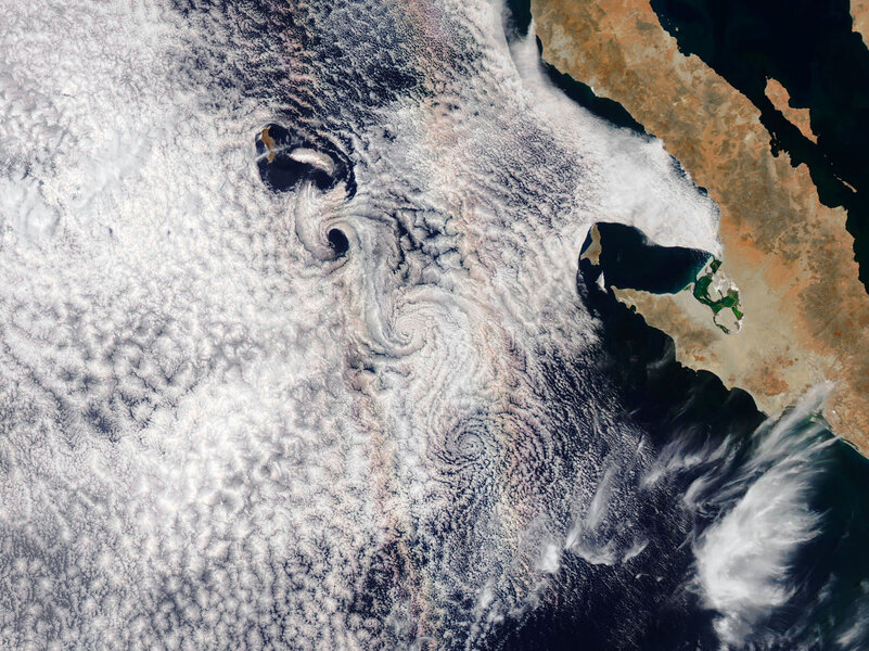 Guadalupe Islands spawns vortices downwind as weird effects stretch a glory out into a pair of parallel lines. Credit: NASA Earth Observatory image by Joshua Stevens, using MODIS data from LANCE/EOSDIS Rapid Response