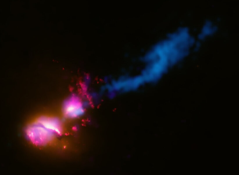 Data from across the electromagnetic spectrum are combined to show that the galaxy 3C321 (lower left) is blasting out a jet of matter that is slamming into a neighboring galaxy (middle) which deflects the jet somewhat (blue, upper right). Credit:     X-ra