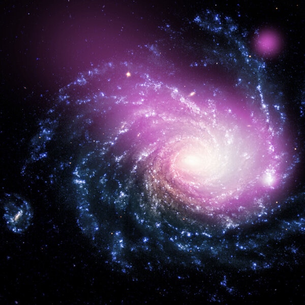 The face-on spiral galaxy is lovely in optical light (blue) but has a very big secret in X-rays (purple). Credit: X-ray: NASA/CXC/Huntingdon Inst. for X-ray Astronomy/G.Garmire, Optical: ESO/VLT