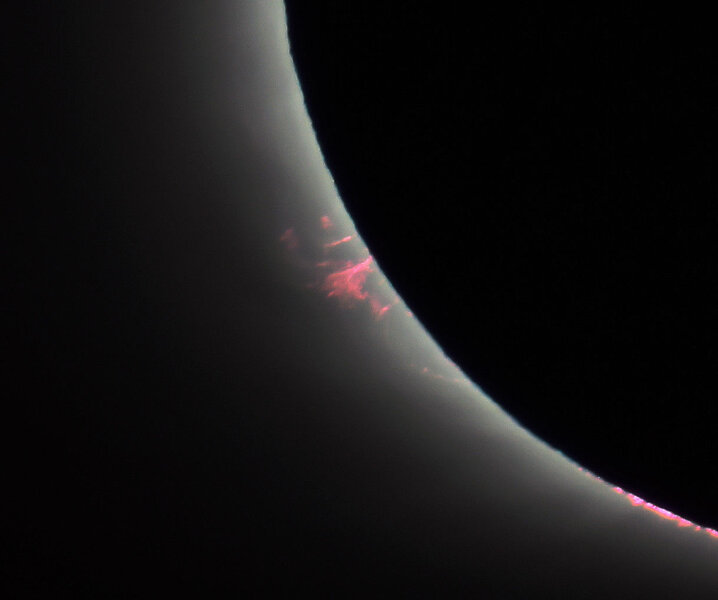 A huge prominence, plasma flowing along lines of magnetic force, erupted from the Sun during the eclipse. Credit: ESA/CESAR