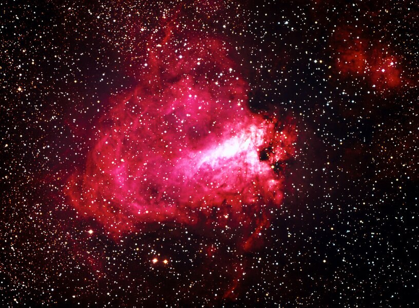 The Swan Nebula in visible light, taken with the ESO 3.6-meter telescope in Chile. The Swan is the bright part in the center (it looks upside-down), and the nebulosity as a whole is called the Omega Nebula, for its resemblance to the Greek letter.
