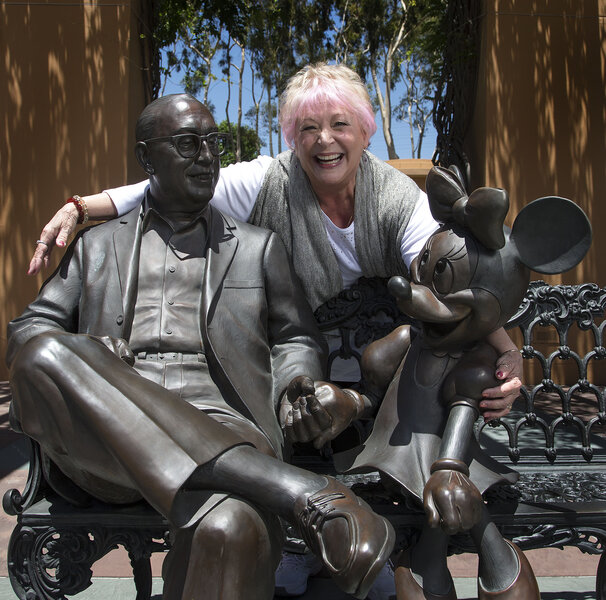 Russi Taylor with Minnie Mouse and Roy O. Disney statues via Getty Images