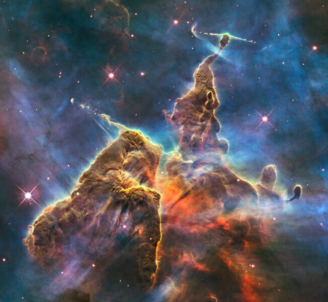 Hubble's view of young stars, gas, and dust in the Carina Nebula. Note the straight jets of material; those are ejected from still-forming stars. Credit: NASA, ESA, M. Livio and the Hubble 20th Anniversary Team (STScI)